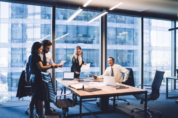 Business executives discussing documents in a modern office, highlighting investment opportunities in Dubai.